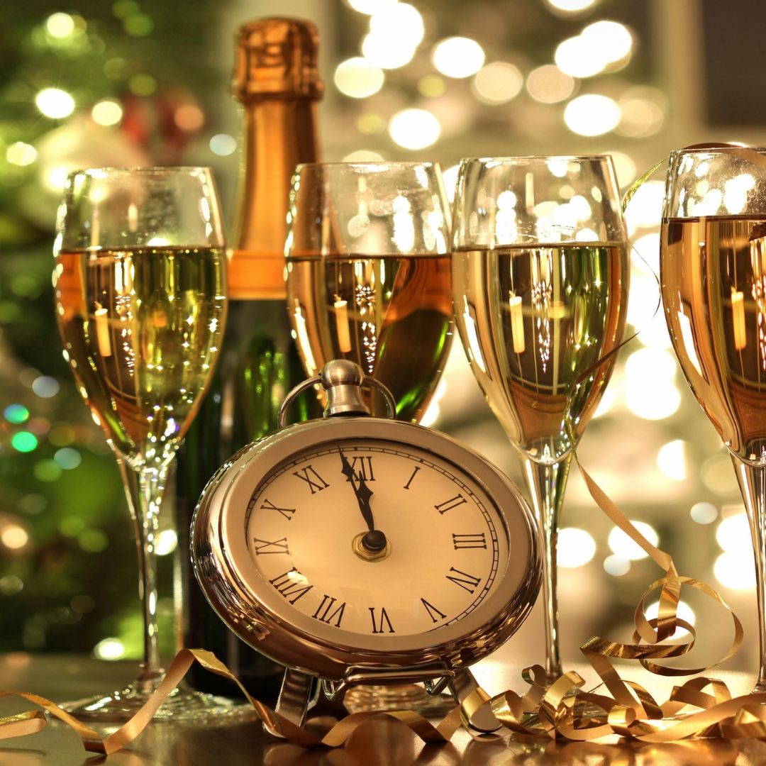 New Year celebration with champagne glasses, bottle and midnight clock representing New Year liquor offers in Nepal by Tipsy Nepal