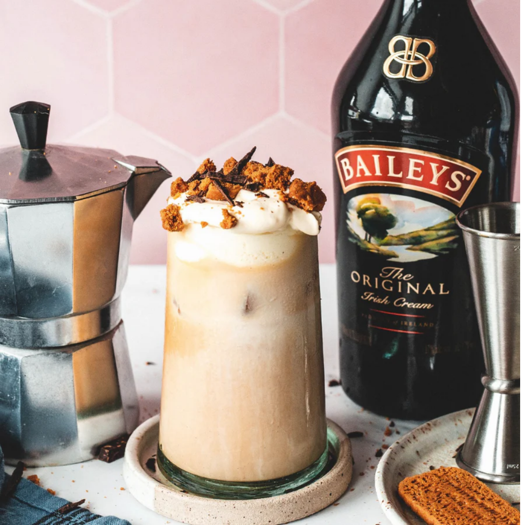 Baileys Irish Cream coffee drink with whipped cream, biscuit topping, moka pot and Baileys bottle in Nepal