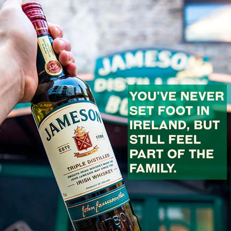 Jameson Irish Whiskey bottle held in hand with Jameson distillery background, showcasing premium triple distilled Irish whiskey in Nepal