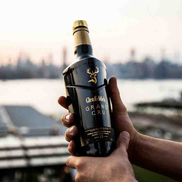 Glenfiddich whisky bottle held outdoors in Nepal showing premium single malt Scotch