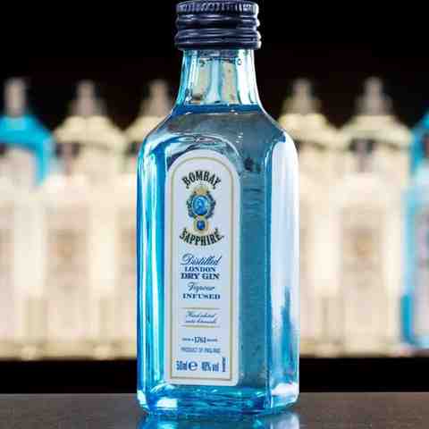 Close-up gallery view of a 50ml Bombay Sapphire Gin miniature bottle with other gin miniatures in the background at Tipsy Nepal.