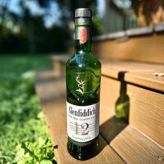 Glenfiddich 12 single malt whisky bottle on a premium bar setup