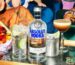 Absolut Vodka bottle with fresh cocktail ingredients on a bar table